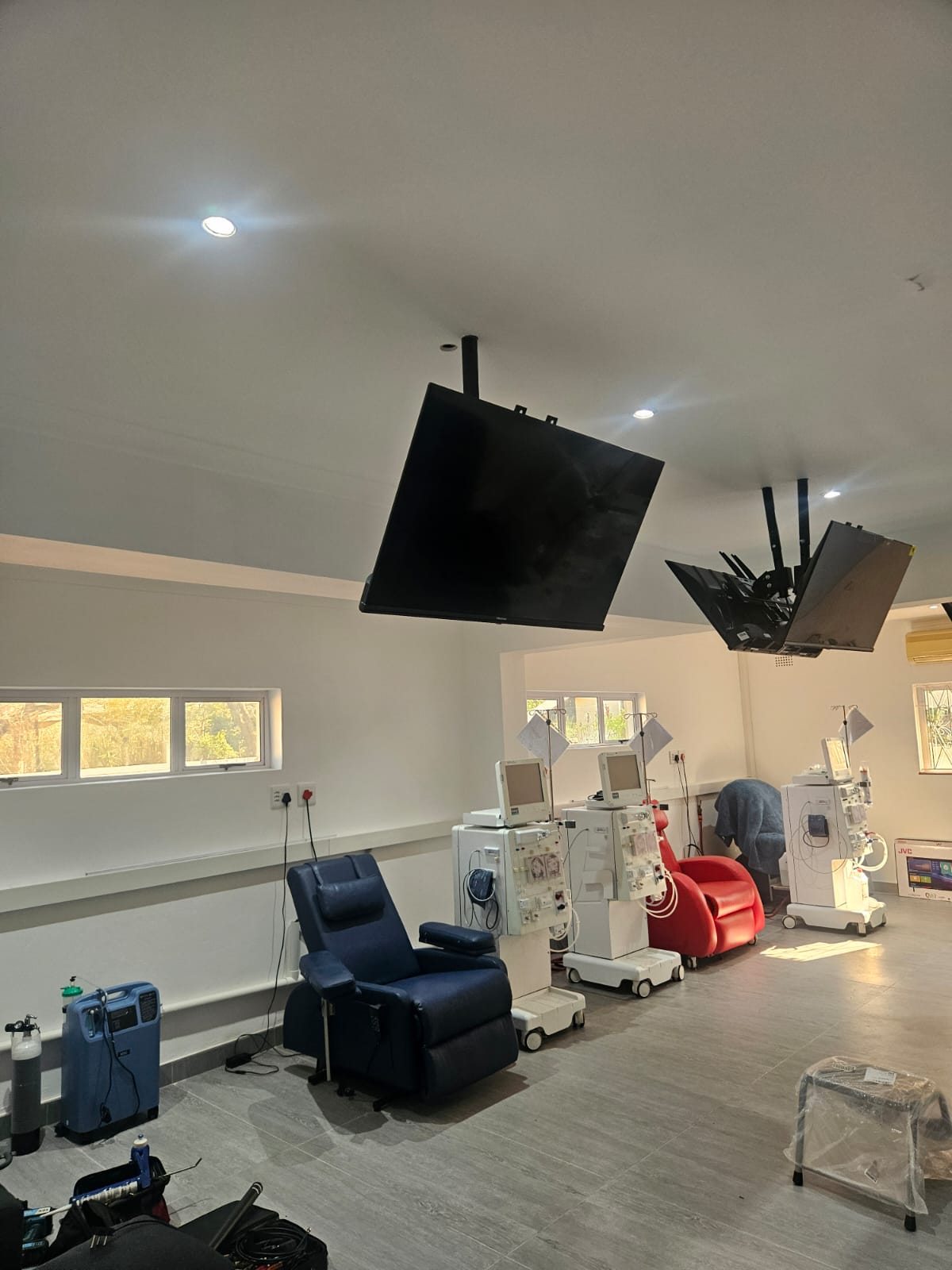 Ceiling-mounted screens installed in a commercial facility